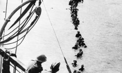 British soldiers wade out to a waiting destroyer off Dunkirk during Operation Dynamo.